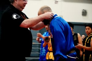 Joseph Vigneri receives the Bronze Medal from judge John Palmer. Congratulations!