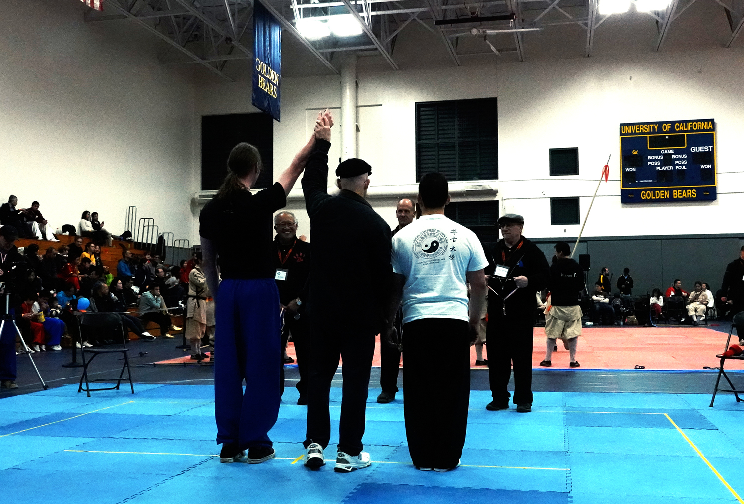 Judge Robert Alexander raises Henry Geddes hand to signal his victory in his match in Tai Chi Push Hands division.